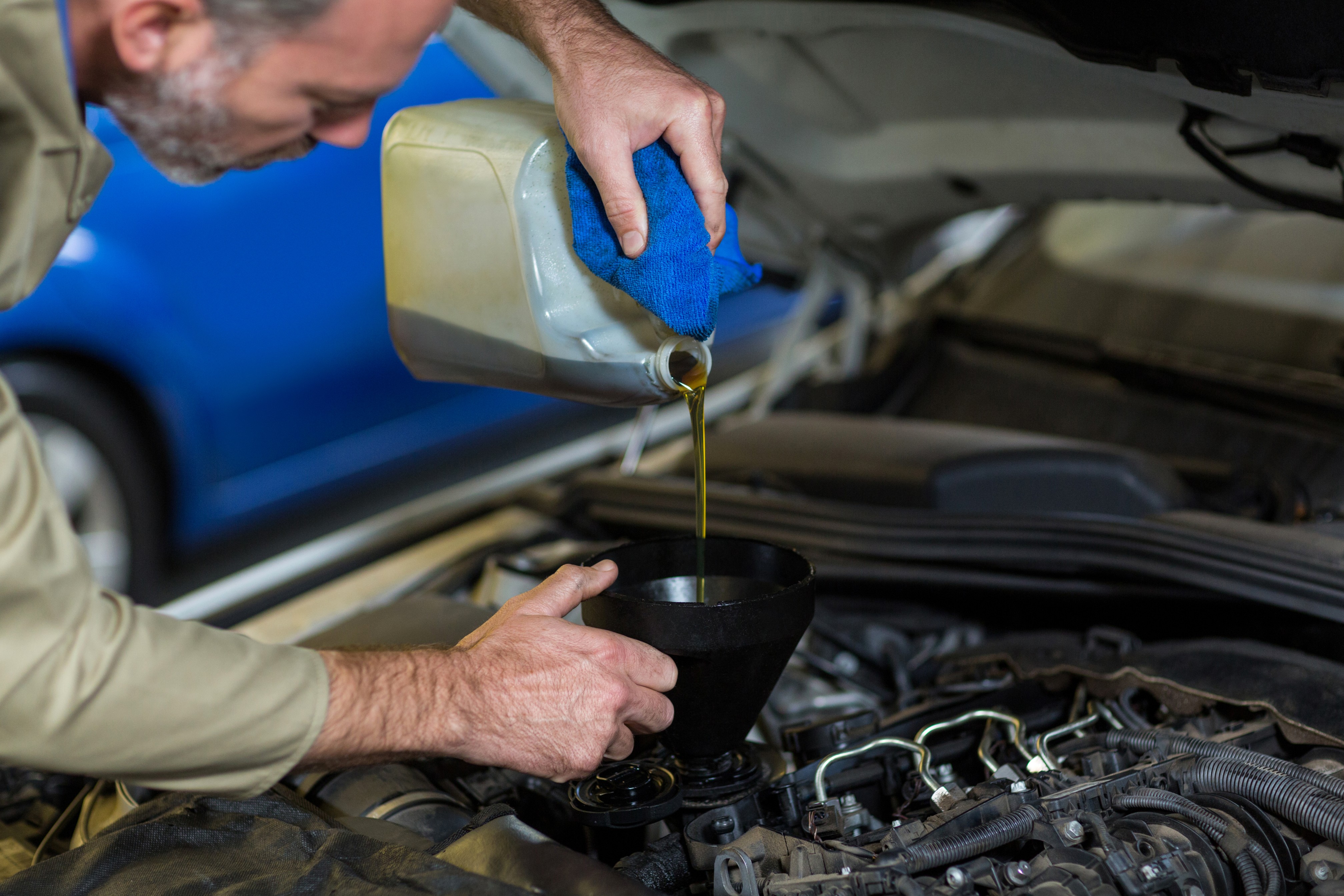mechanic-pouring-oil-into-car-engine (2).jpg